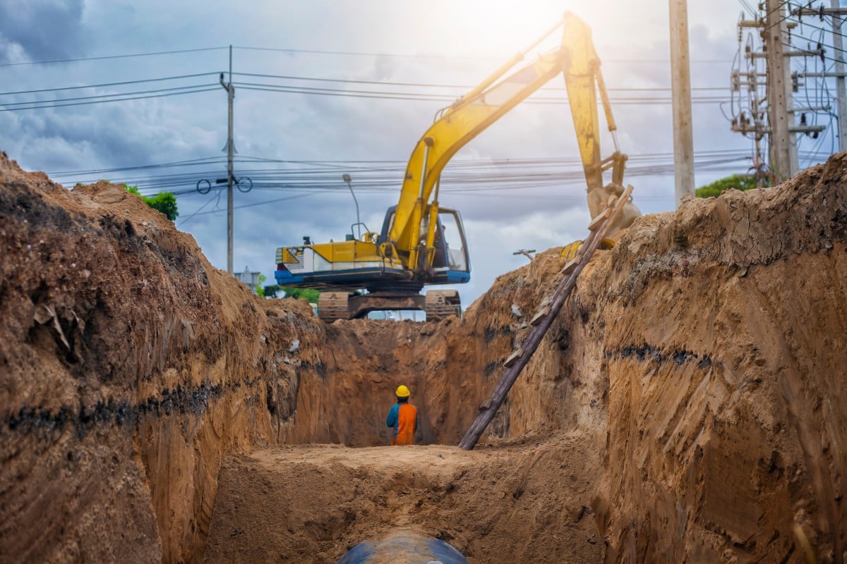Emergency excavation crew working on deep utility trench repair