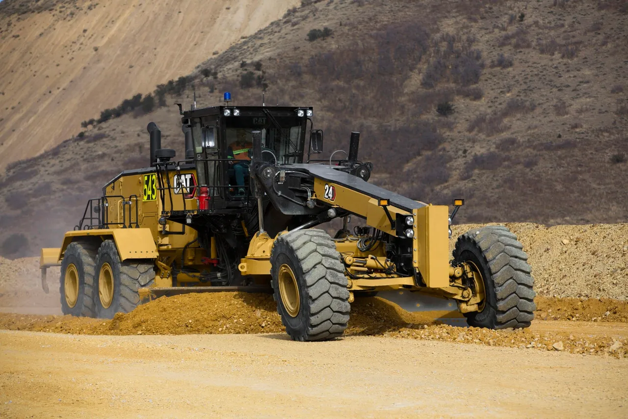 Motor grader performing finish grading for landscaping and drainage